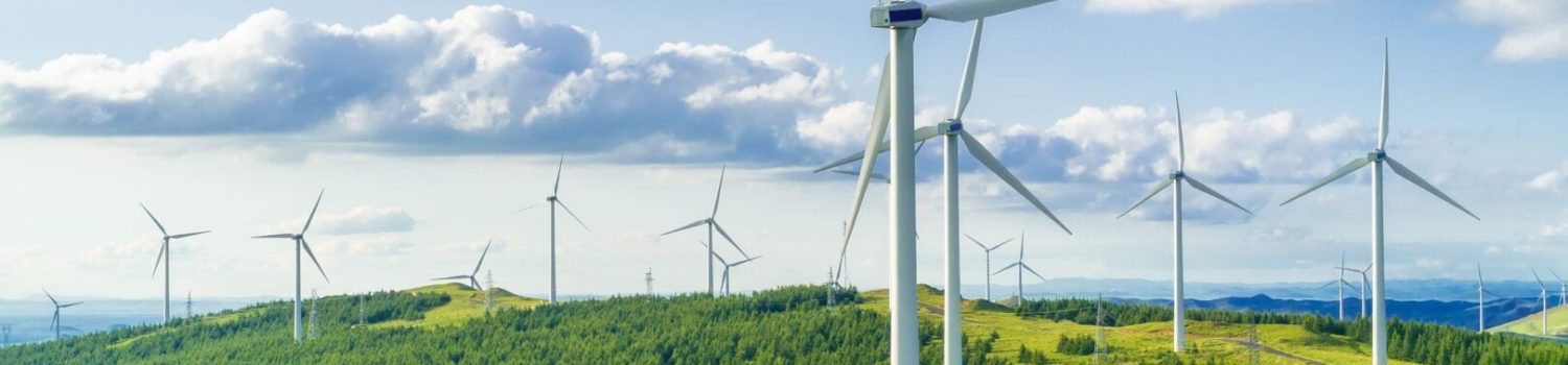 Wind turbines on green rolling hills