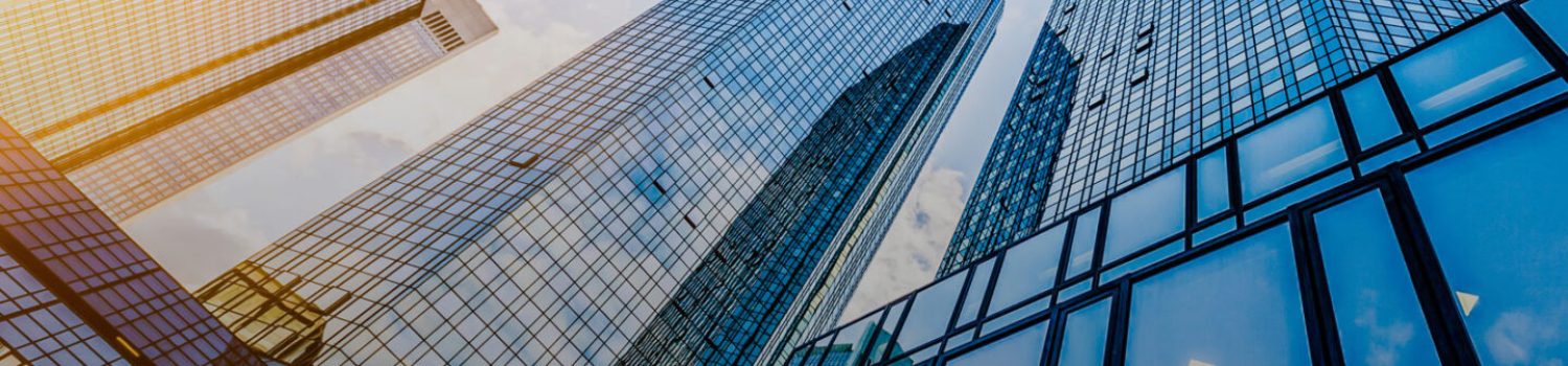 Monthly Reports Wrap Up-July 2019-image 2 Reflective glass skyscrapers towering into blue sky