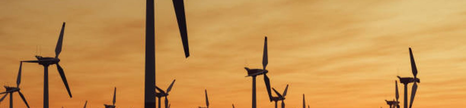 Offshore wind turbine farm at sunset.